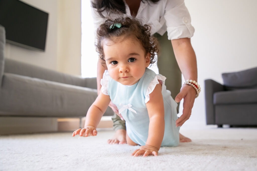Sweet baby crawling on floor at home